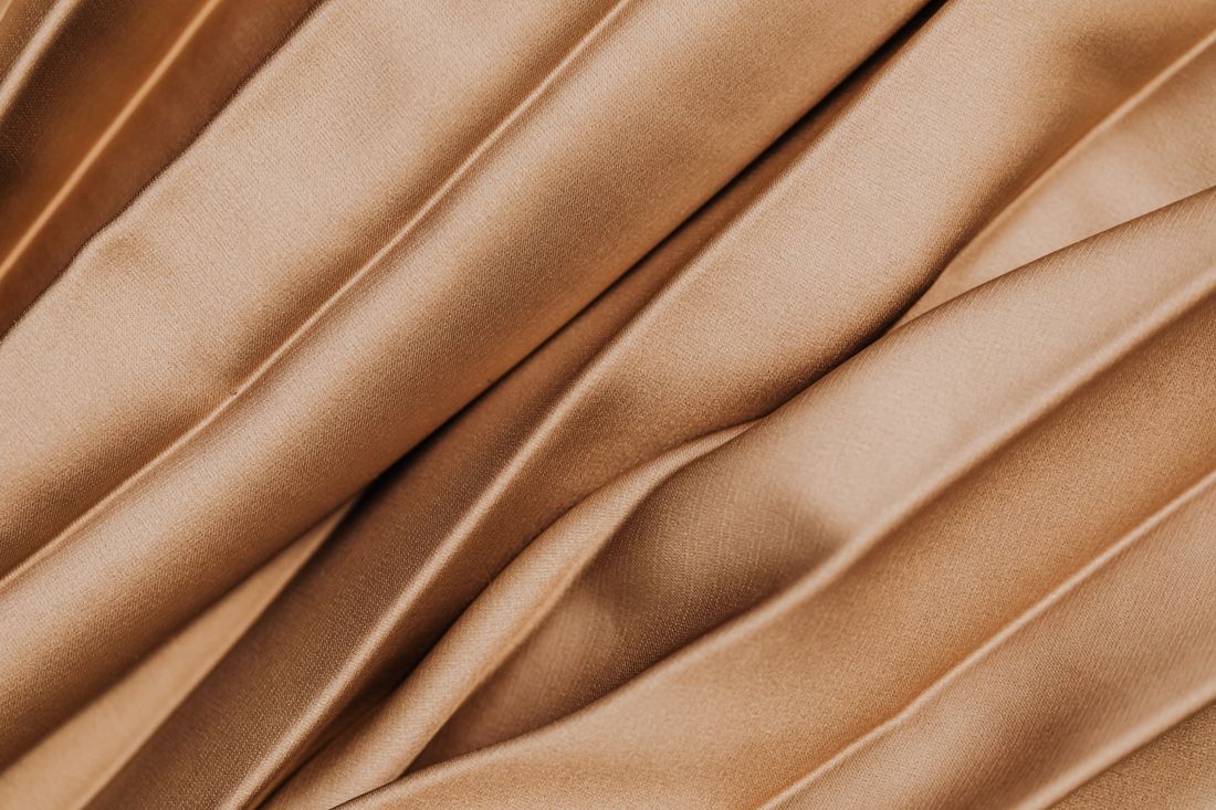 Close view of warm beige pleated fabric